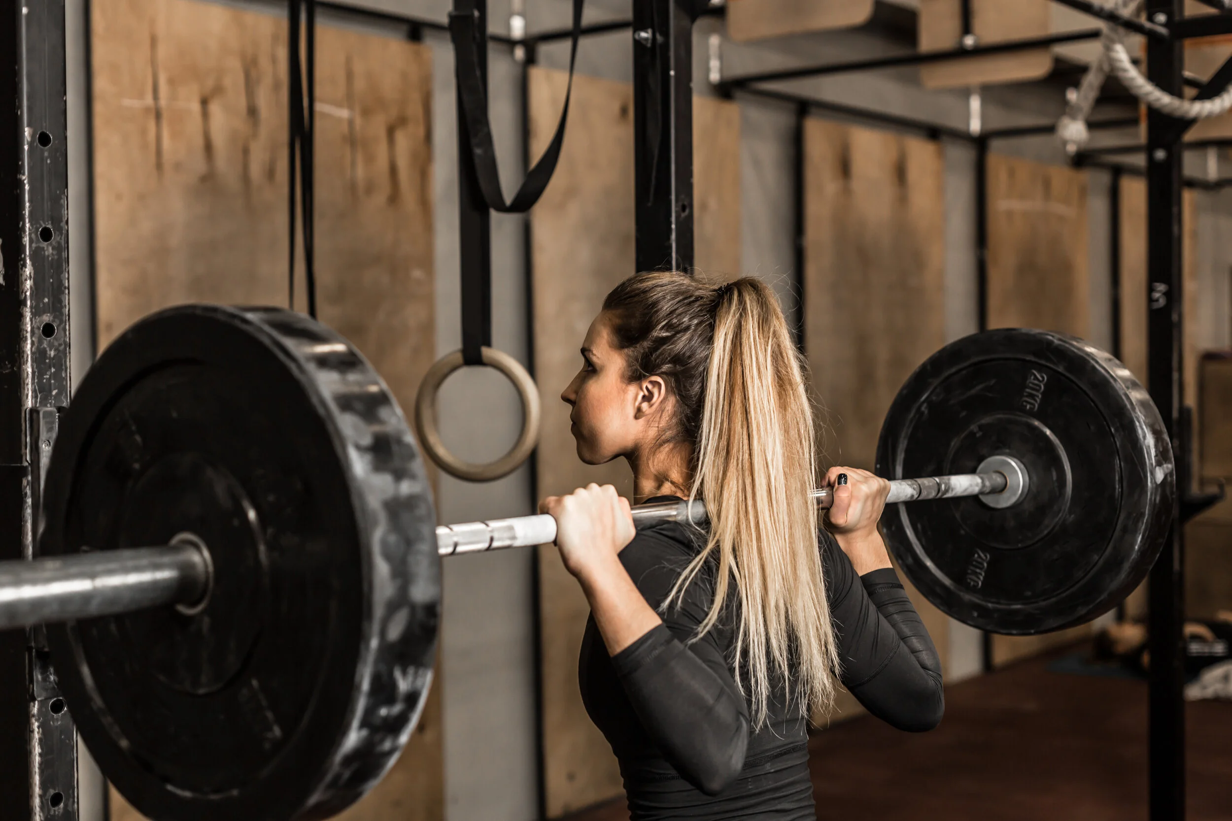 An athlete lifting a loaded barbell